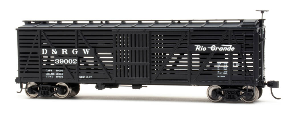 Color photo of HO scale stockcar painted black with white graphics on white background