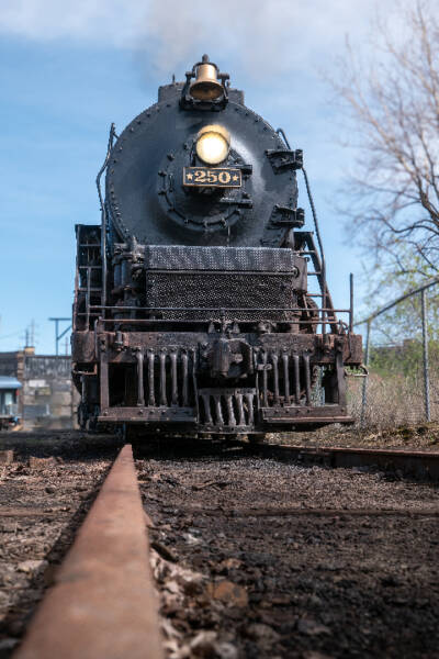 Looking down the rails at large black steam locomotive. Cleveland railroad event to celebrate locomotive No. 250’s 80th birthday.