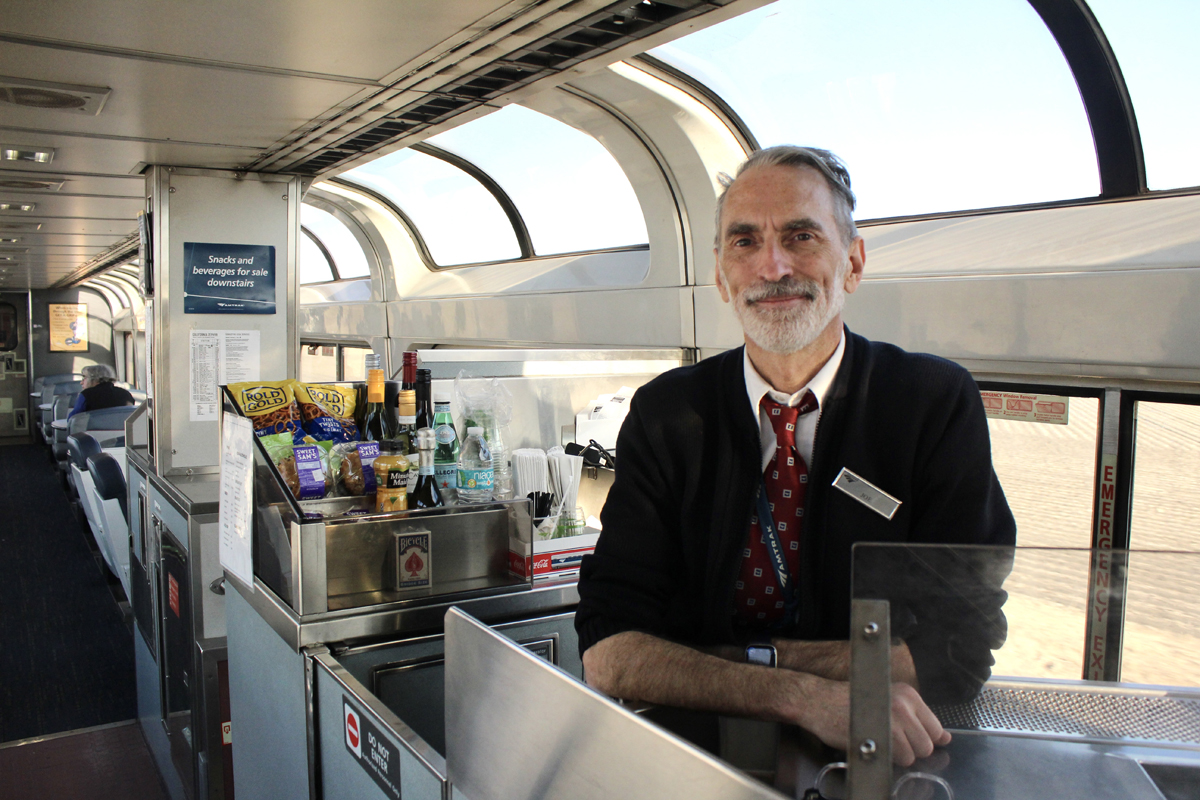 Train staff member posing in Superliner lounge