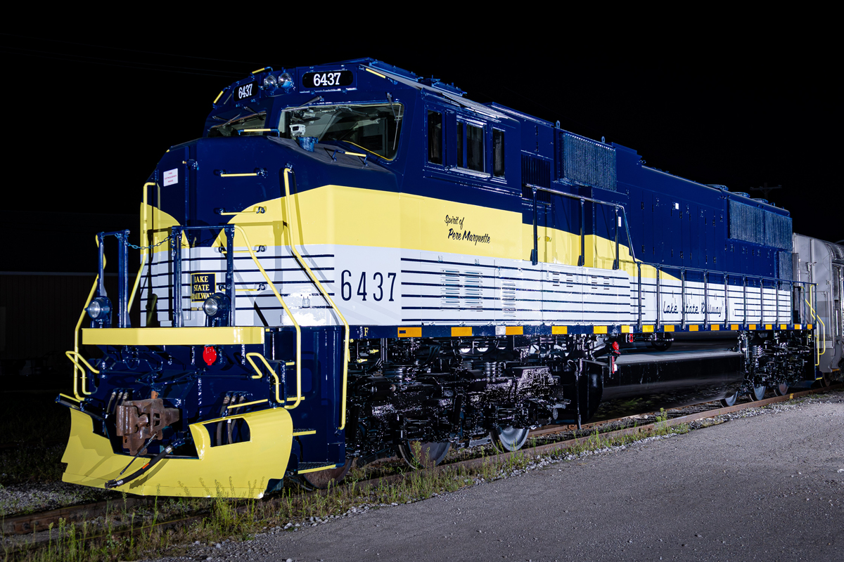 Dark blue, yellow, and white locomotive