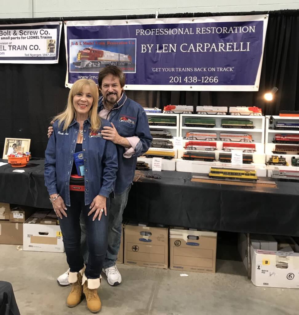man and woman standing next to show booth