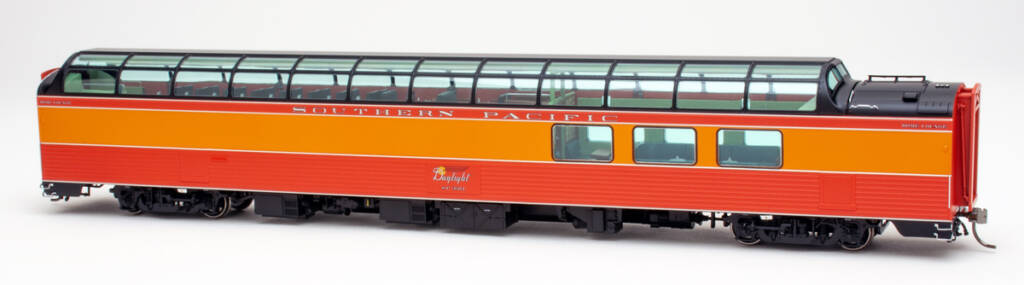 Color photo of HO scale 3/4 dome lounge passenger car painted orange, red, silver, and black on white background. 