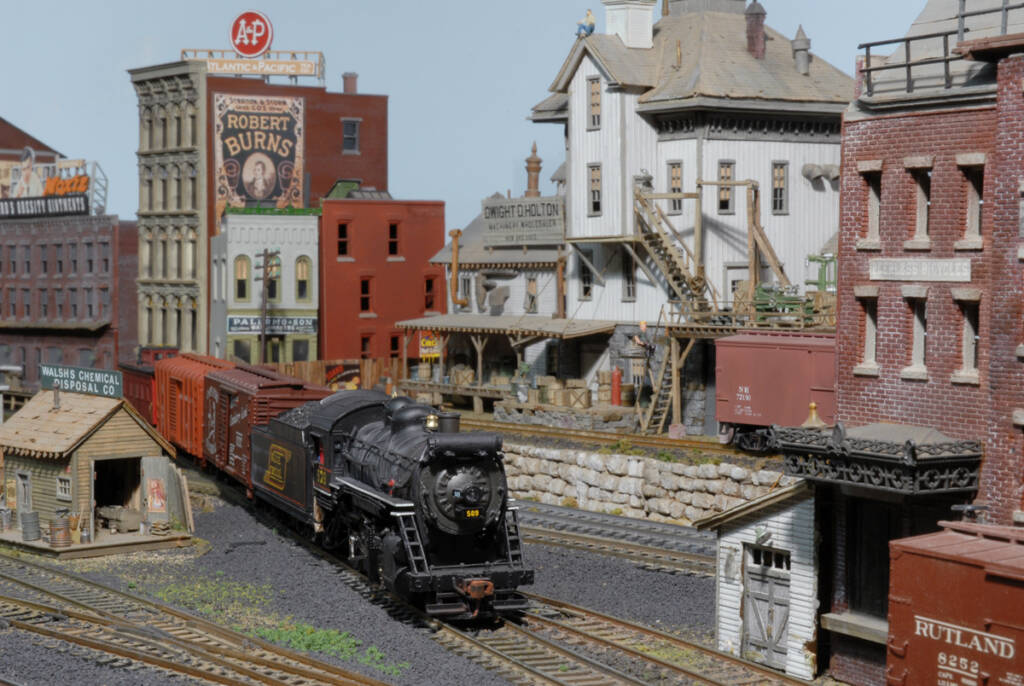 A model steam locomotive on a model railroad layout