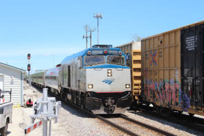 Cab-control car on an Amtrak passenger train, passing a freight train.