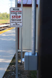 Flag stop sign on train platform.