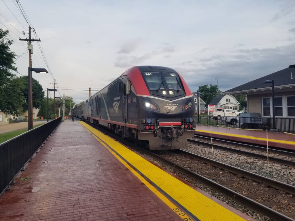 Modern diesel-powered passenger train arrives at a station