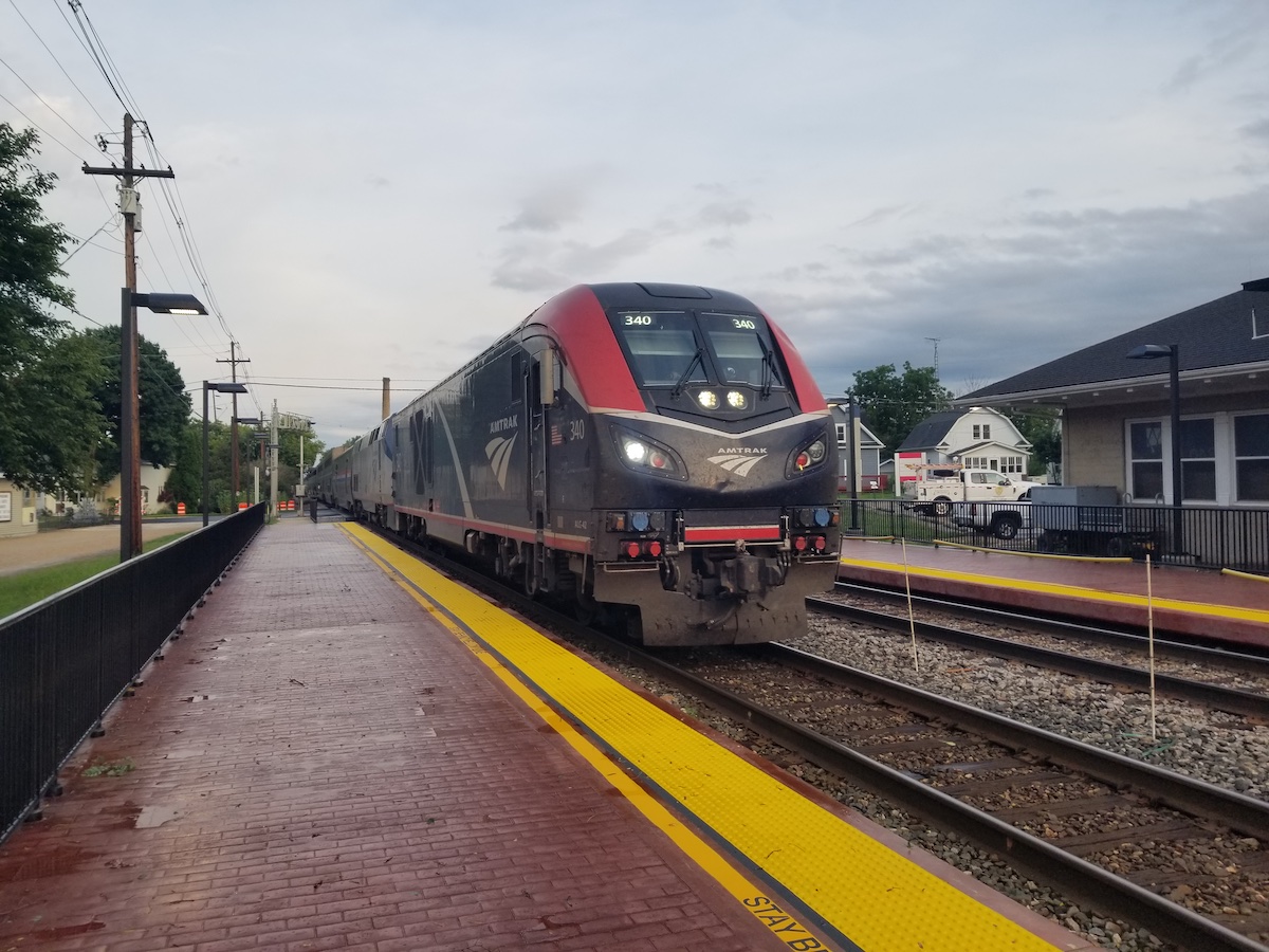 Modern diesel-powered passenger train arrives at a station