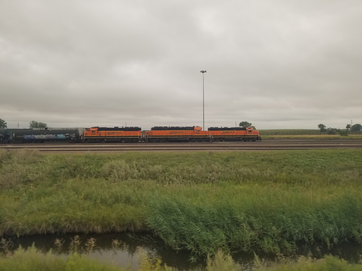 Passing by a freight train through the windows of a passenger train