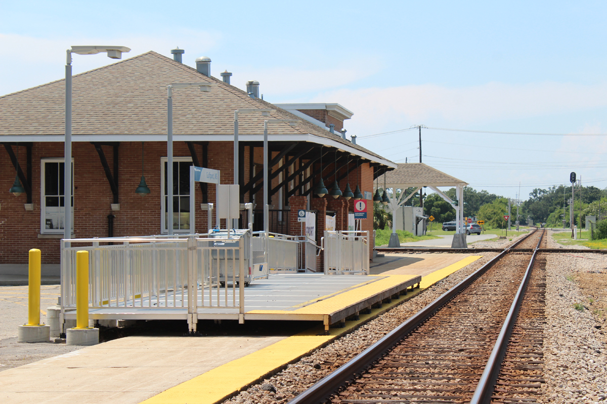 Station platform and former station building next to single railroad track