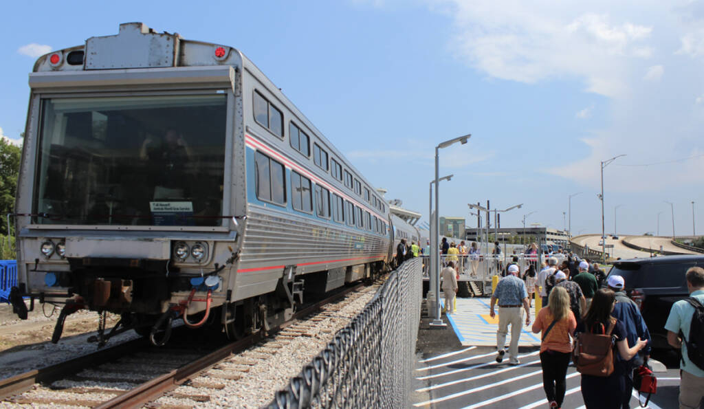 Passenger car with large glass rear window at station