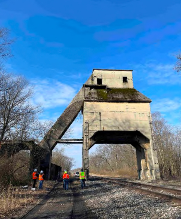 View of coaling tower with workers in foreground