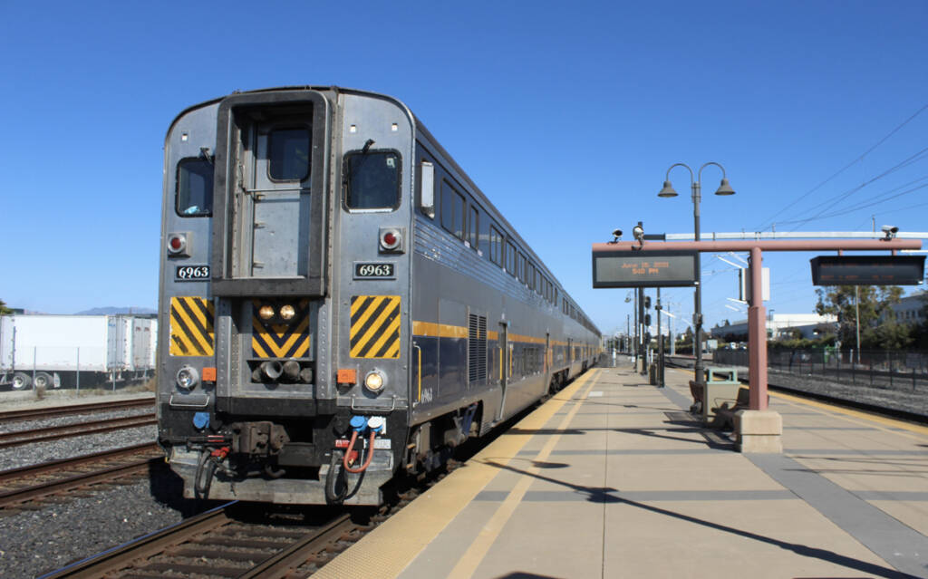 Cab car leading passenger train at station