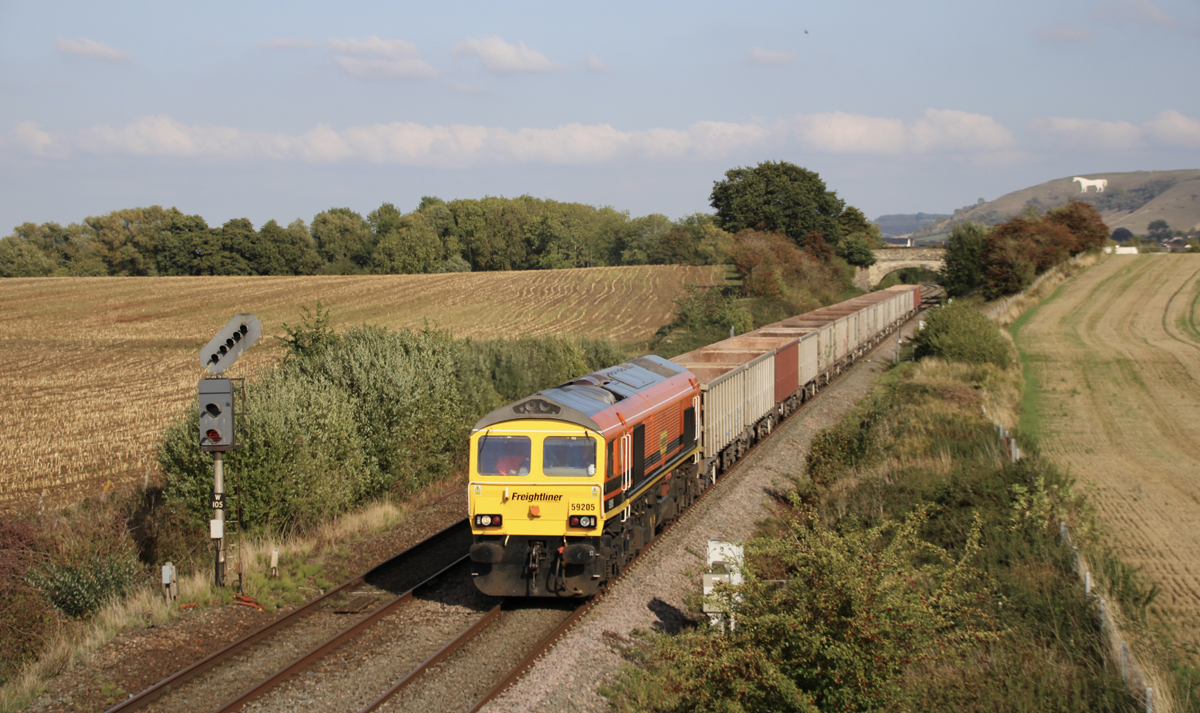 Orange, yellow, and black double-cab diesel on freight train