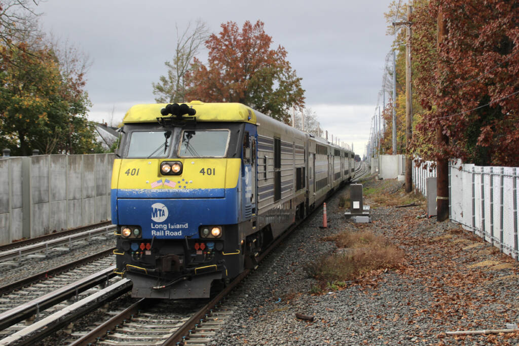 Blue and yellow diesel locomotive on commuter train