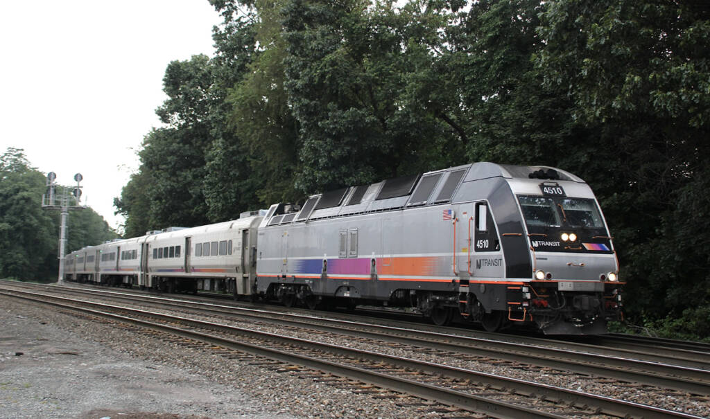 Commuter train with silver locomotive and single-level passenger cars
