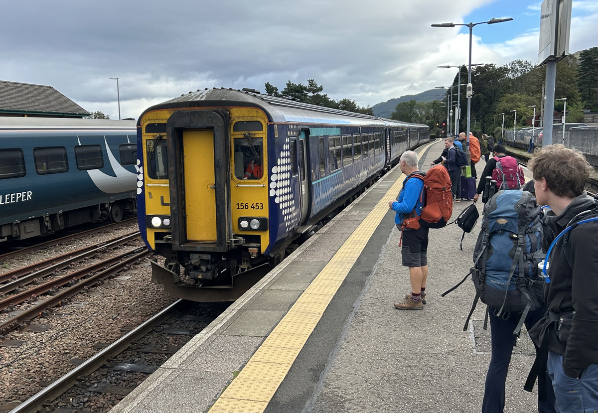 Four-car train arriving at station