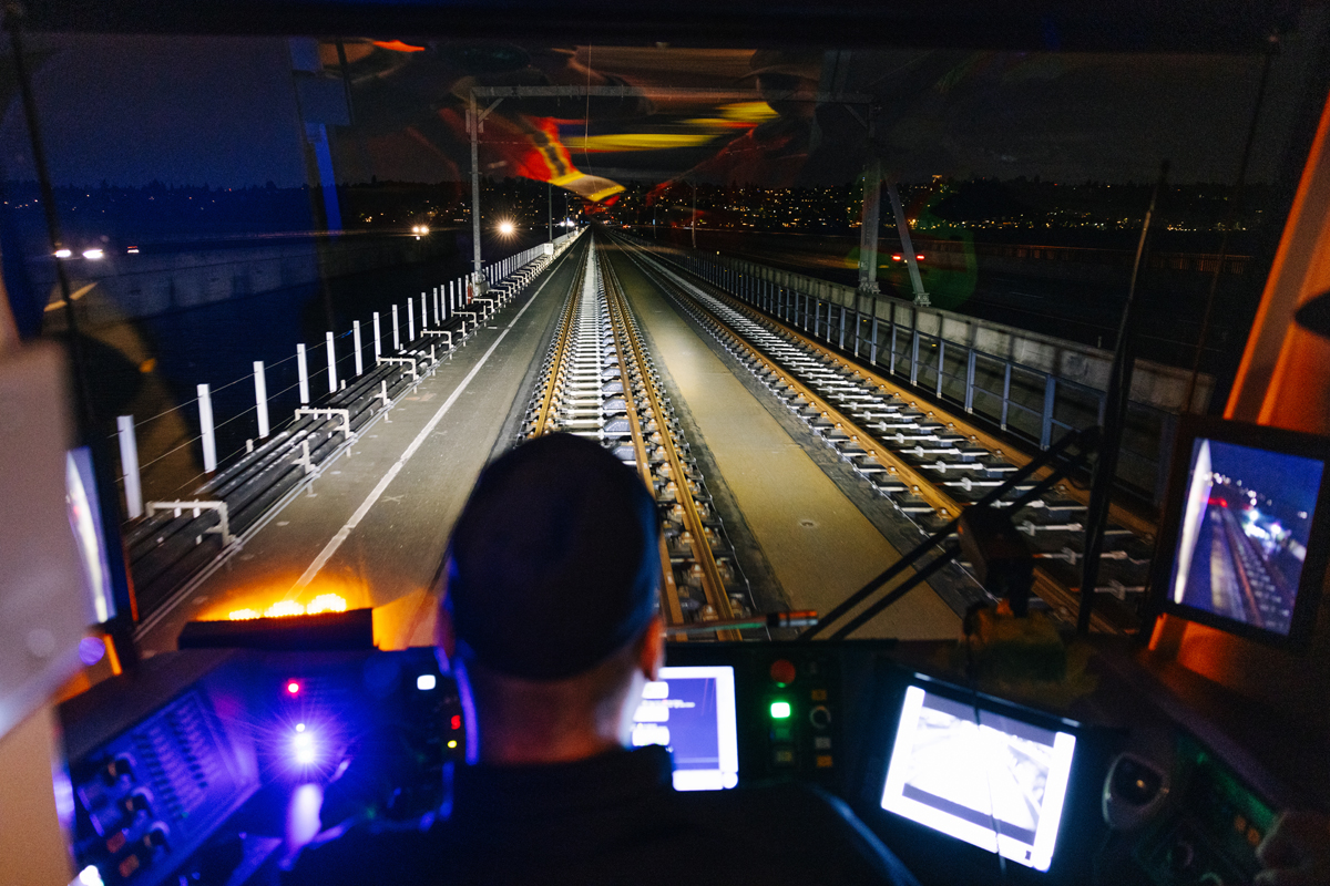 View from light rail vehicle of bridge at night
