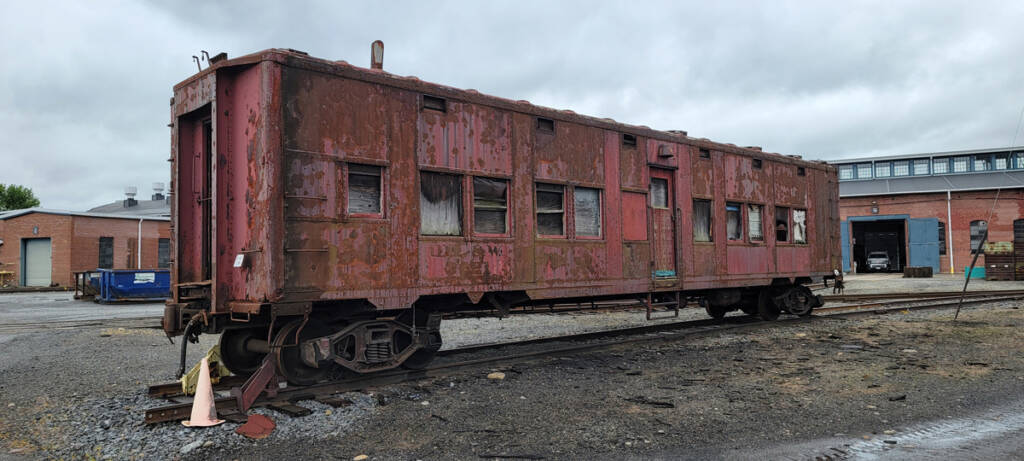 Rusted and weathered boxcar-like railcar