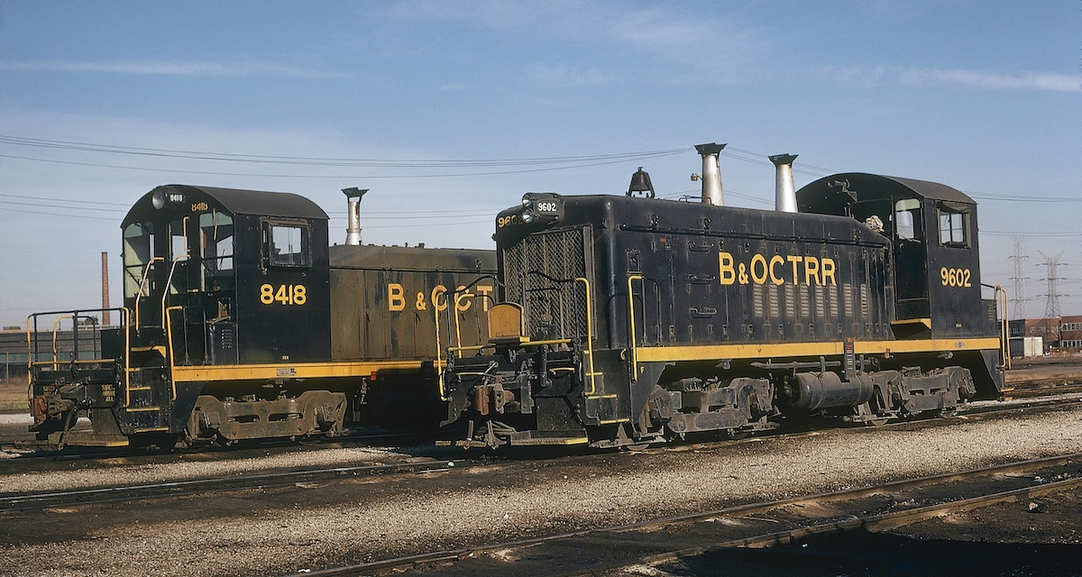Blue-and-yellow diesel switchers in a yard