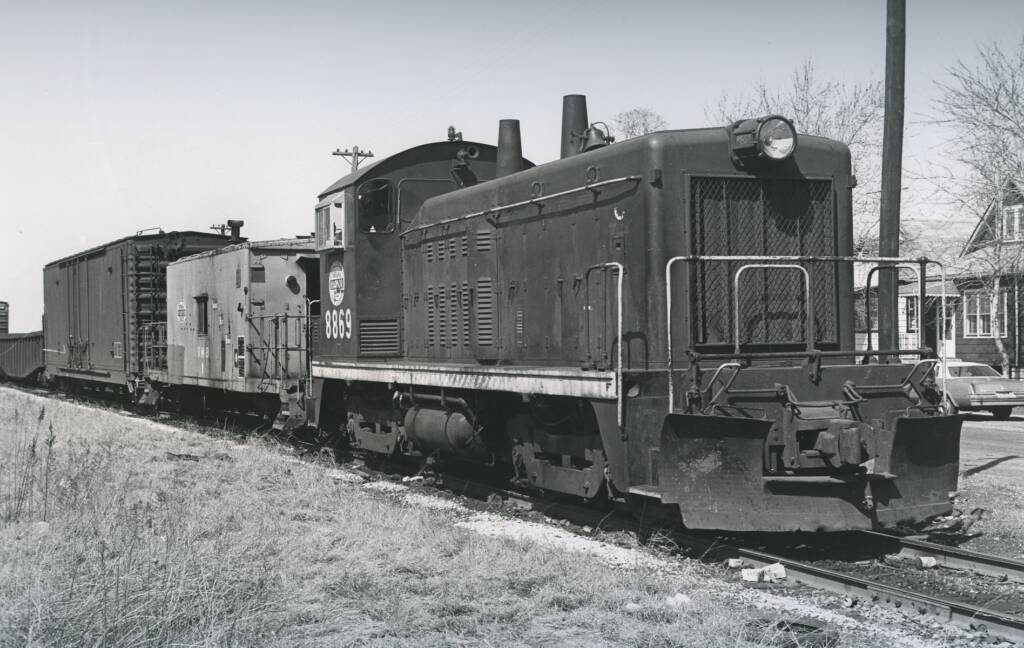 Back-and-white photo of a switcher operating in rural area