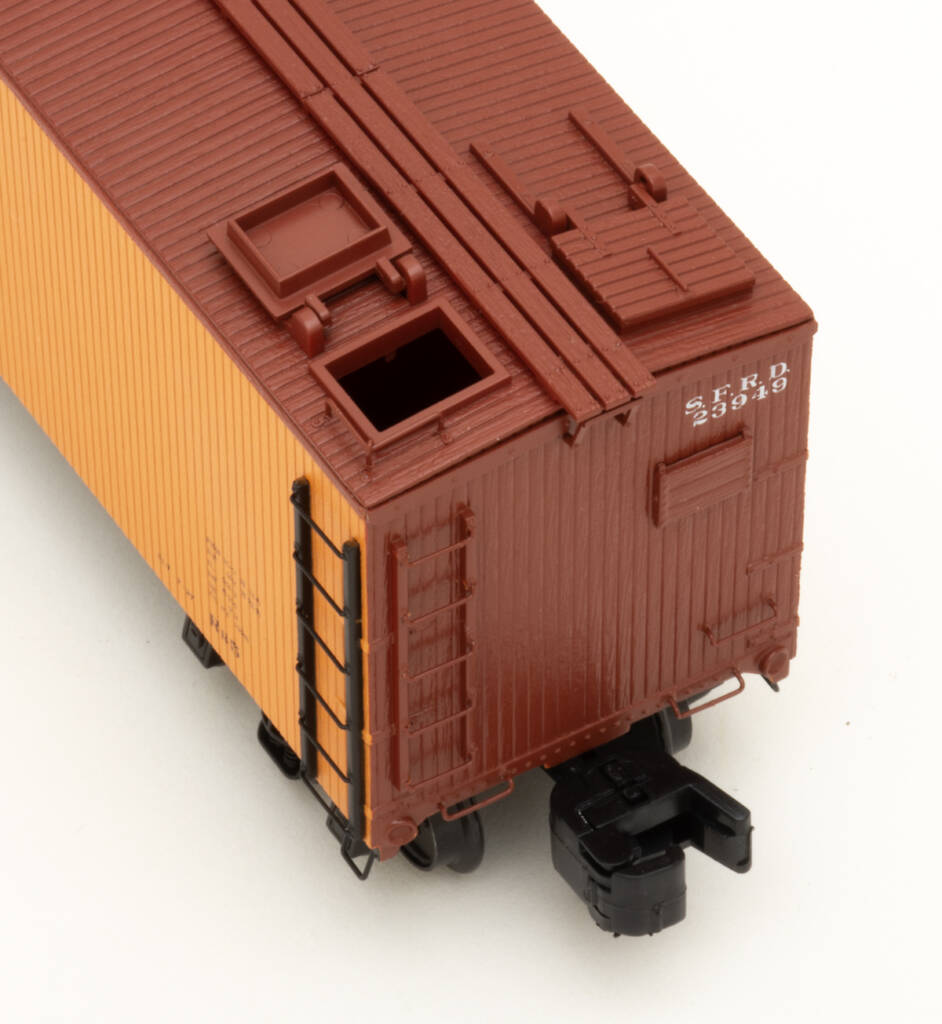 Overhead photo showing roof details on S gauge wood refrigerator car painted yellow-orange and mineral brown on white background.