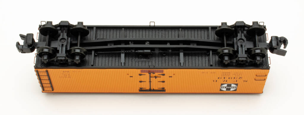 Color photo showing underbody of S gauge wood refrigerator car on white background.