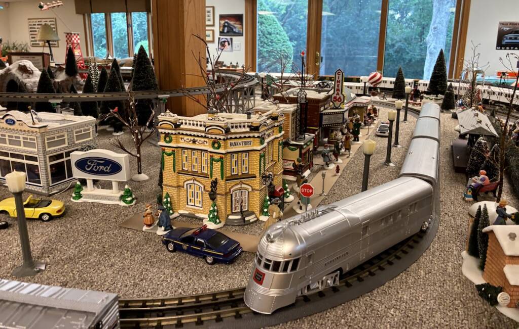 silver model train on corner of toy train layout