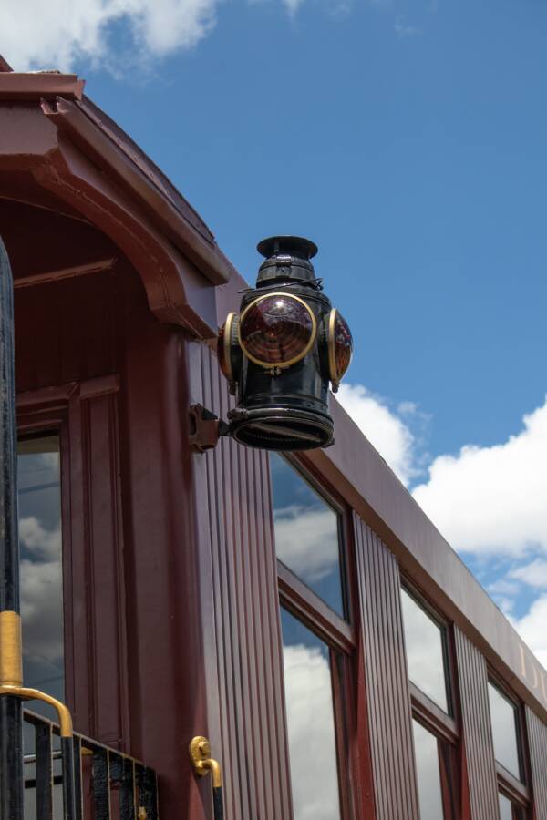 detail of a wooden passenger car showing a mounted railroad lantern