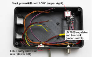 inside view of bottom half of case with wiring, plugs, and switches installed