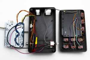 inside view of top and bottom sections of the case with wiring connections between circuit boards shown
