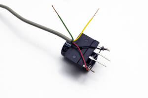 gray silicon rectifier attached to large capacitor with wiring attached