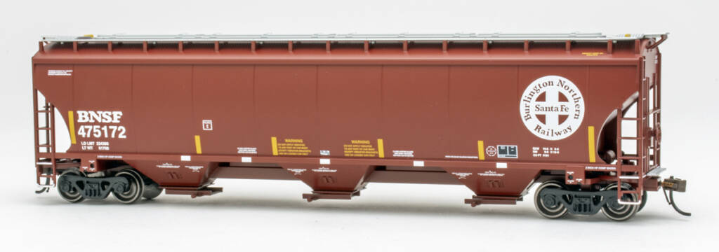 Color photo of HO scale three-bay covered hopper painted Mineral Red with white, black, and yellow graphics 