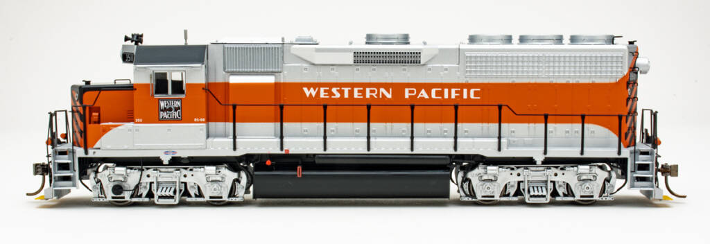 Color photo showing side view of HO scale hood unit painted aluminum, orange, and black on white background.