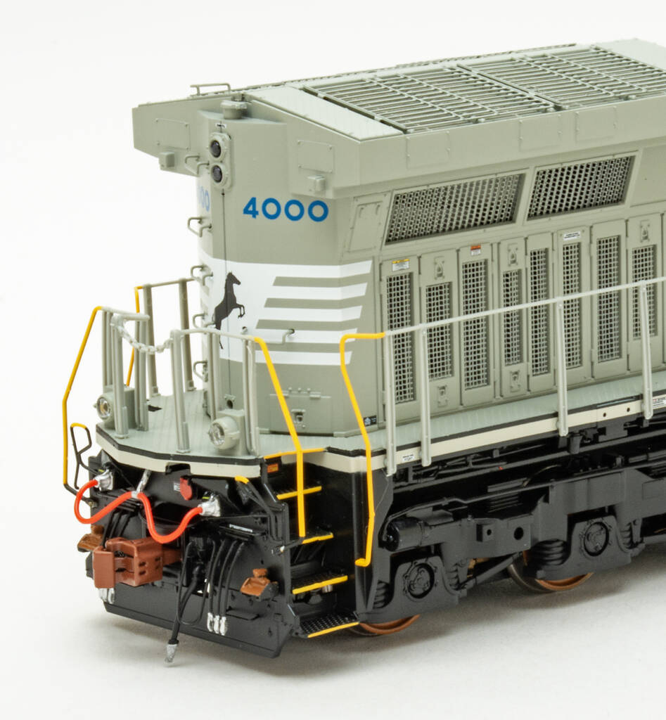 Color photo showing rear of long hood on HO scale diesel painted gray, white, blue, and black.