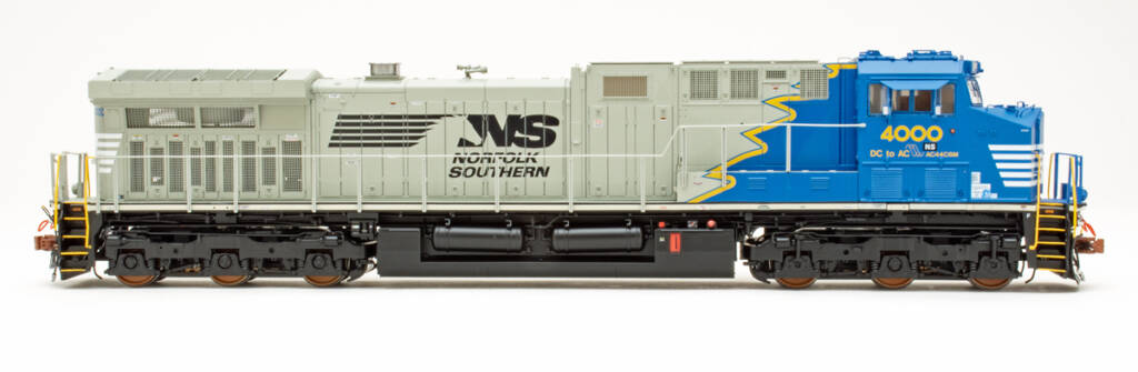 Color photo showing engineer’s side of HO scale diesel painted blue, yellow, gray, black, and white.
