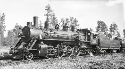 Historic black and white photo of a logging steam locomotive. Temple Lumber Co. No. 20 moves to a new home.