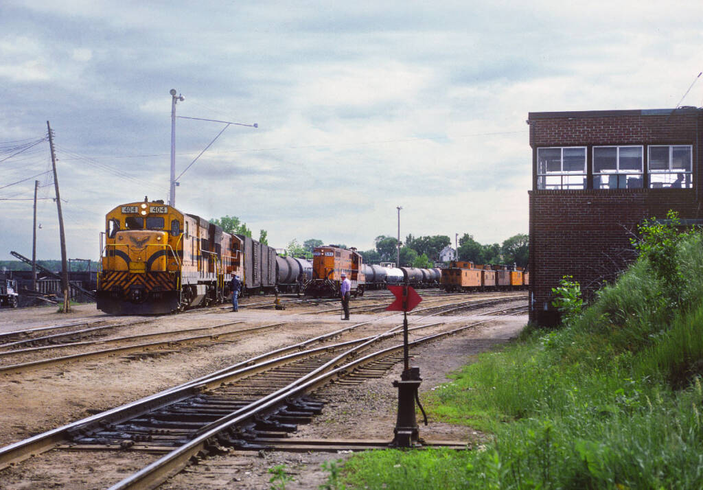 Yellow and orange diesel locomotives switching a yard. A fishy call in the night.