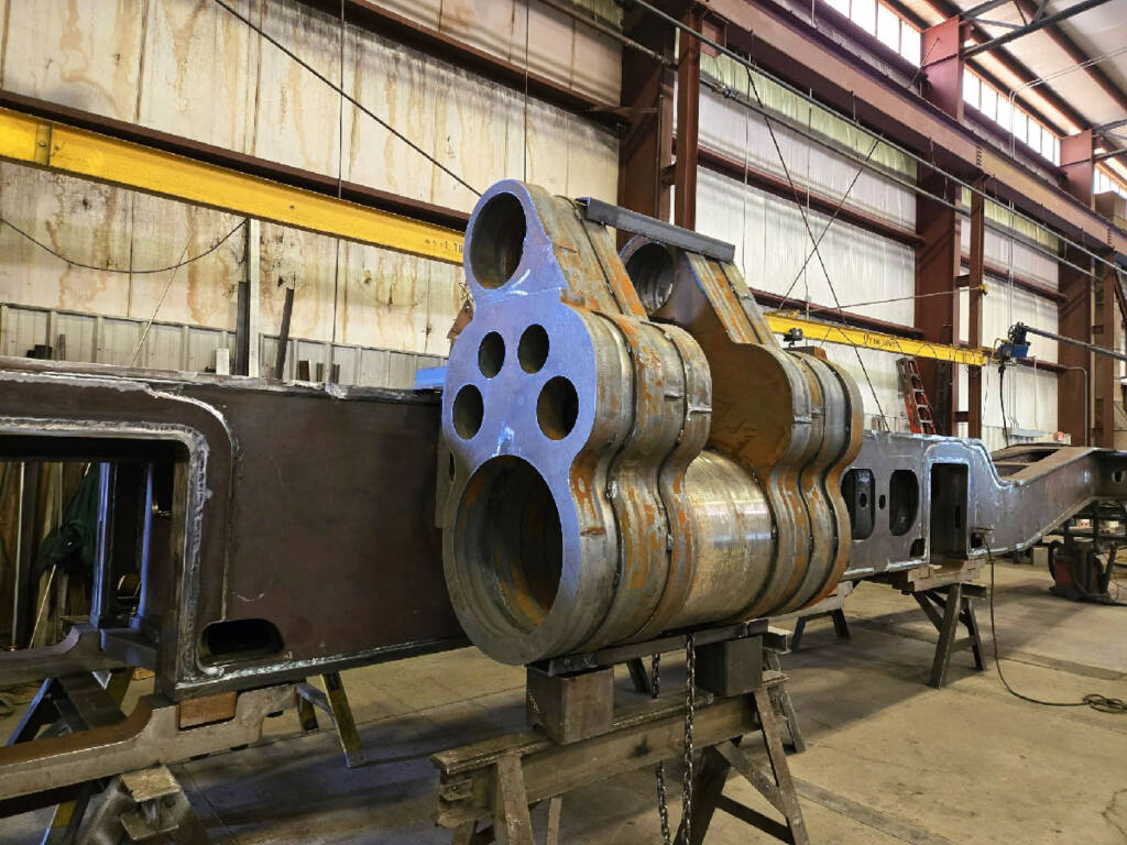 Unfinished T1 steam locomotive cylinder temporarily mounted to engine frame.