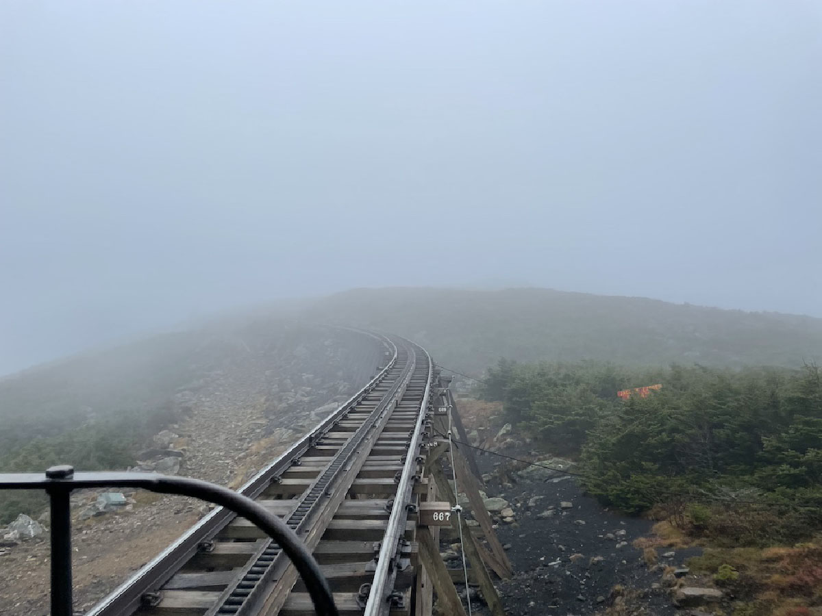 Looking up mountain on a cog railway into the fog. Mount Washington Cog Railway rescues hikers