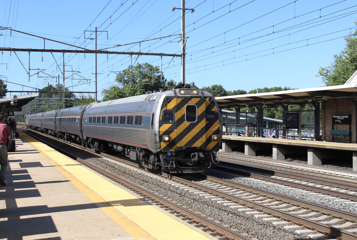 Amtrak Northeast Corridor train led by cab car with orange and black nose stripes