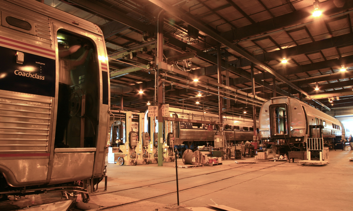 Passenger cars inside shop building with orange-tinted lighting