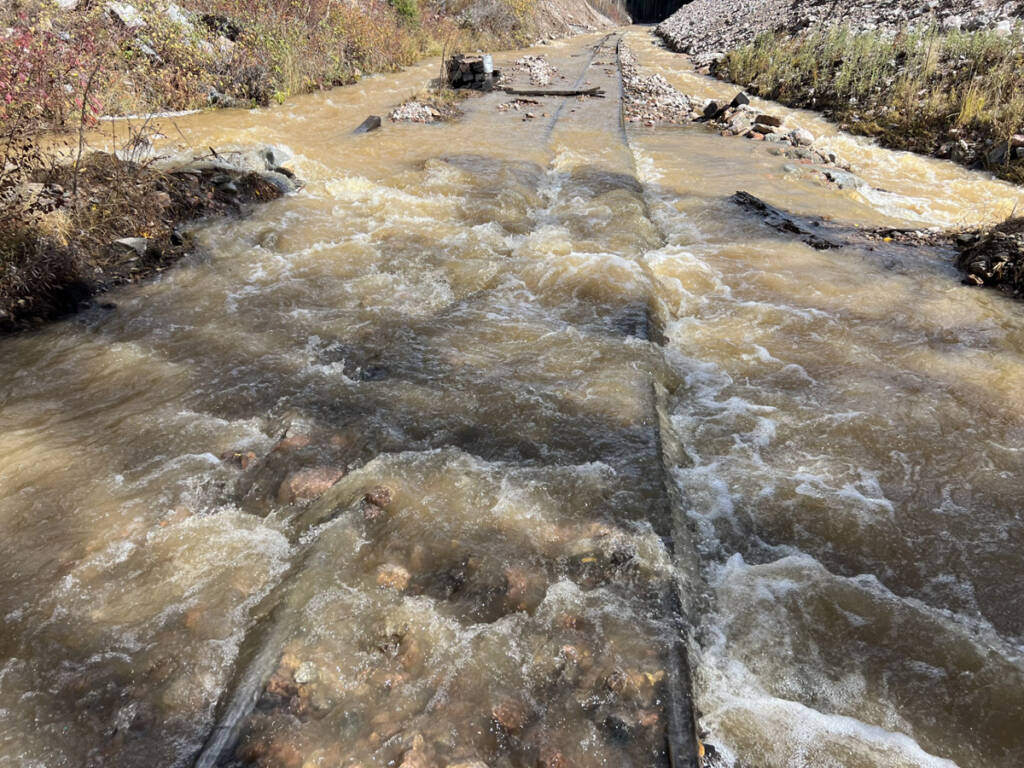 Water running over narrow-gauge rail line