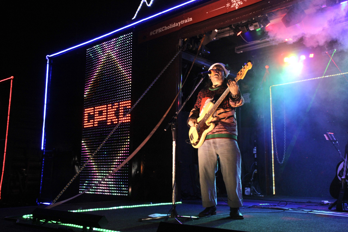 Musician playing with CPKC logo in background