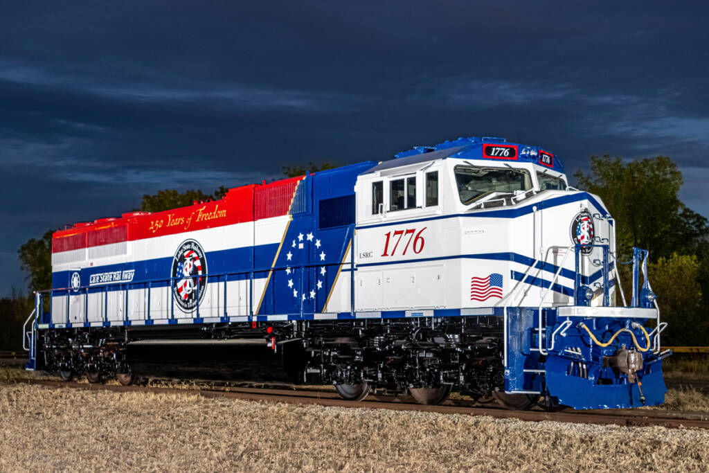 White locomotive with red and blue striping