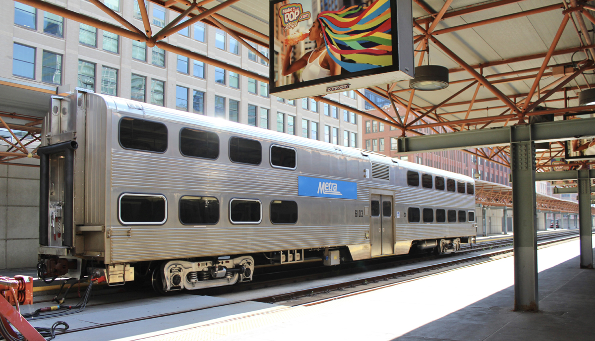 Stainless steel bilevel commuter car at station platform