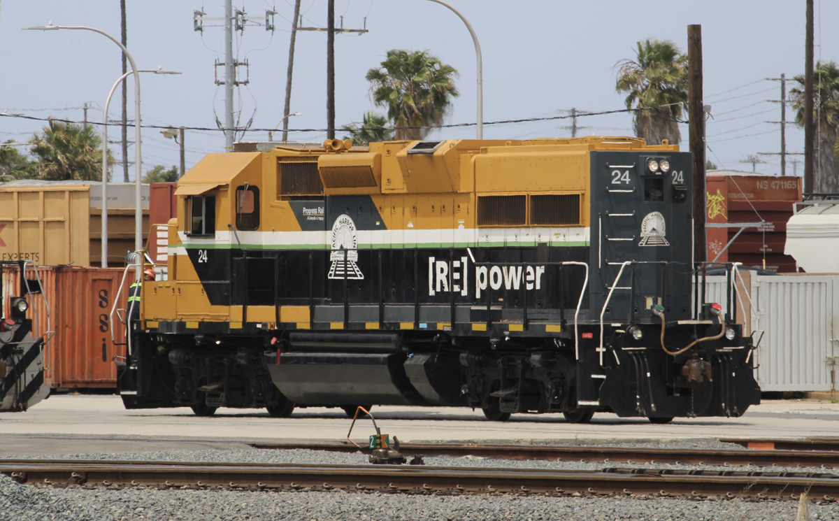 Black and yellow locomotive in yard