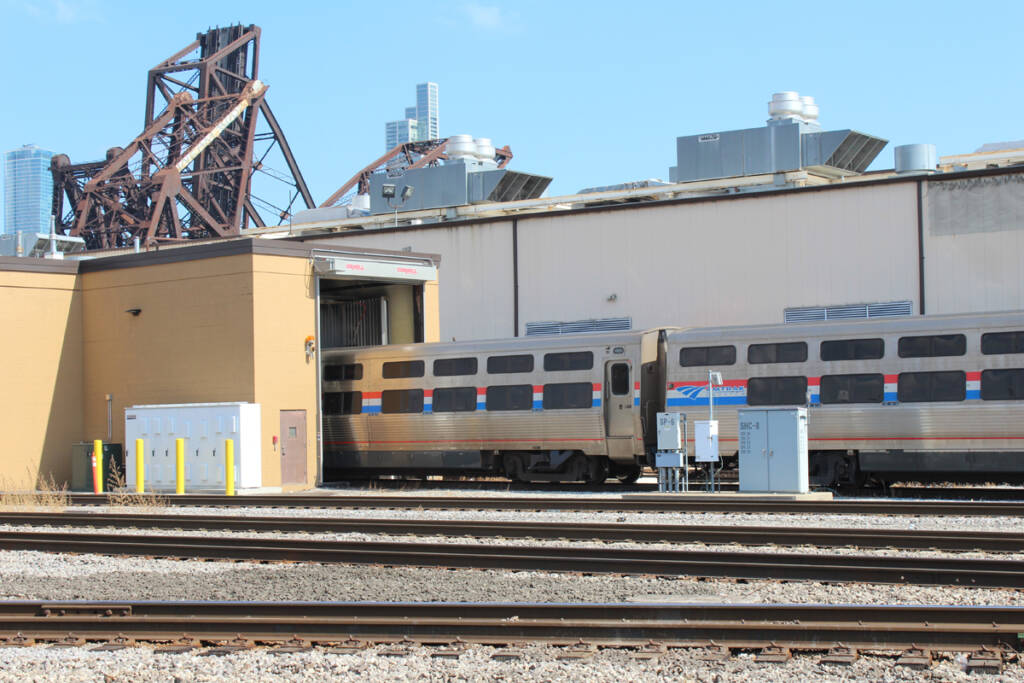 Passenger cars entering small building