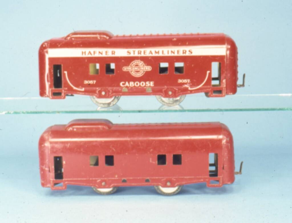 two old red tinplate cabooses