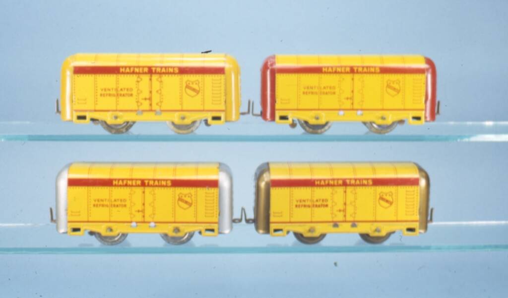 four yellow vintage toy train cars