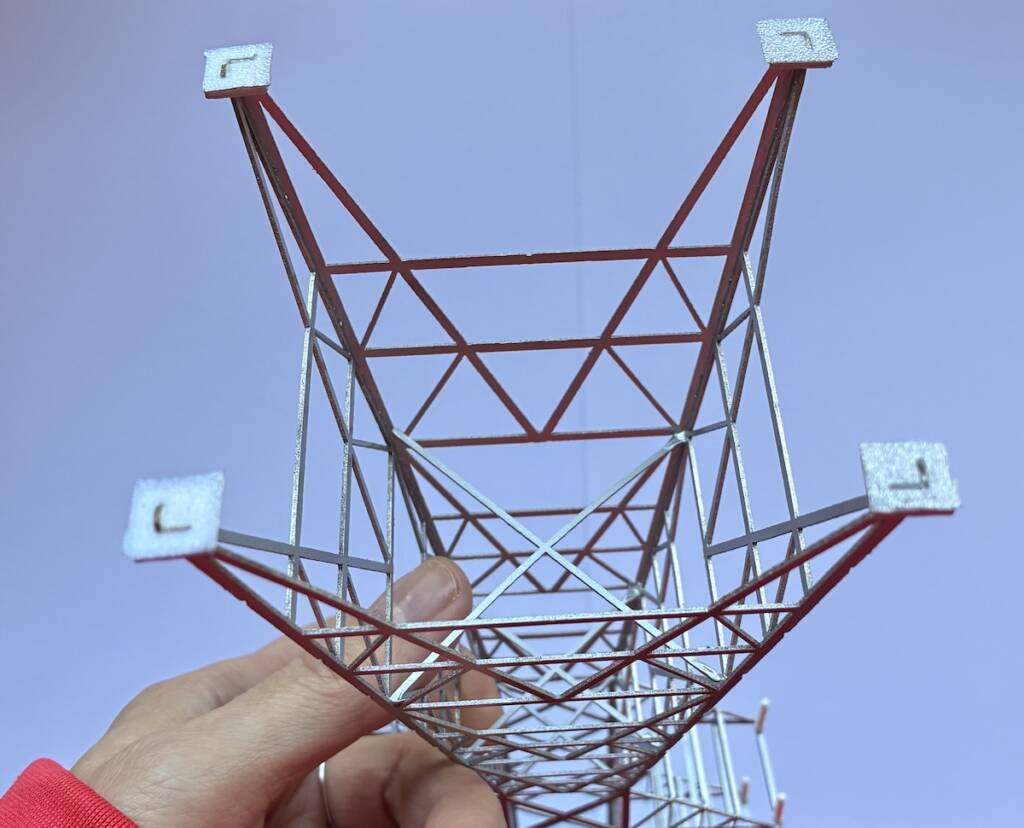 hand holding model electrical tower